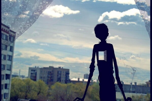 Figura scura di un ragazzo con una finestra sul posto del cuore