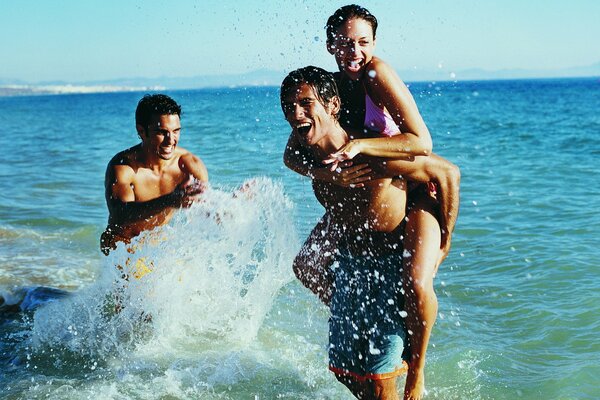 Friends play in the water and splash