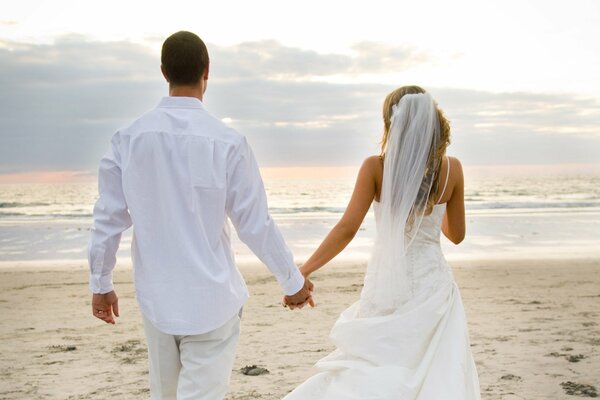 Wedding photo on the beach. Newlyweds