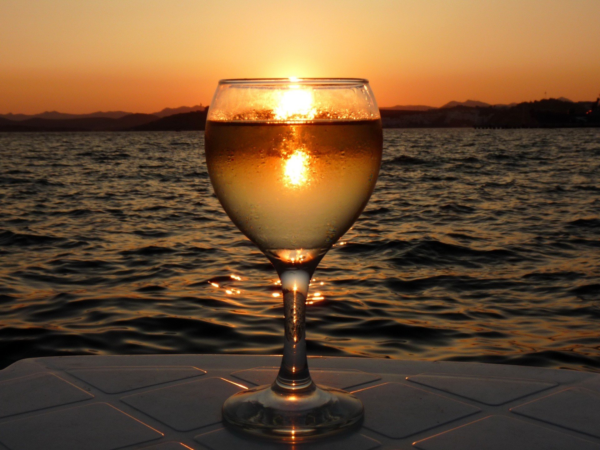 copa de vino puesta de sol agua