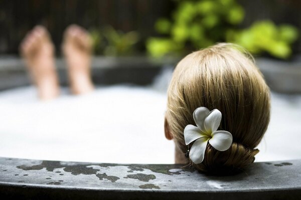 The girl relaxes in the bath