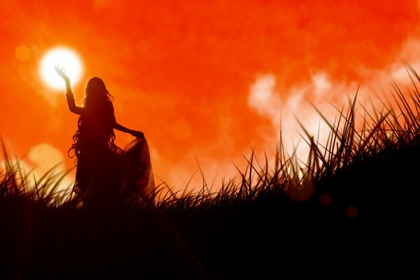 A girl at sunset on the grass