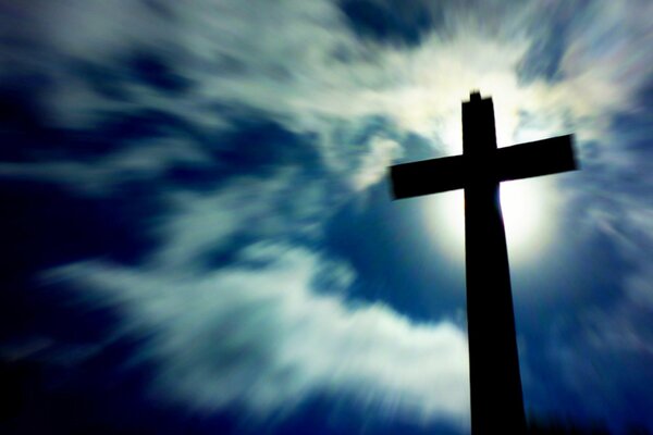 Cross with light in the cemetery