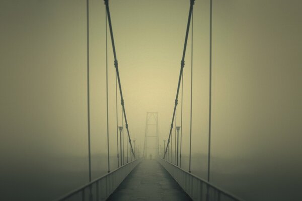 Brumoso puente de la mañana sobre el río