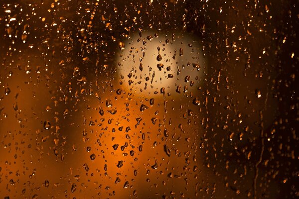 The rain left drops on the glass of the evening window