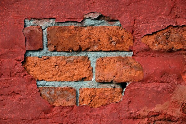 Fond de mur de briques fissurées