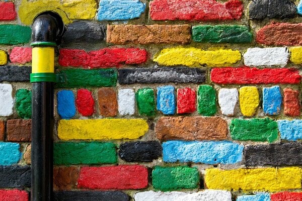 Creatively painted brick wall with a pipe