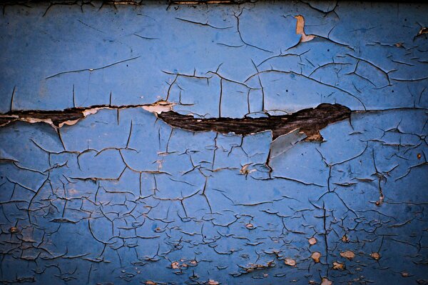 Blue cracked paint on the wall