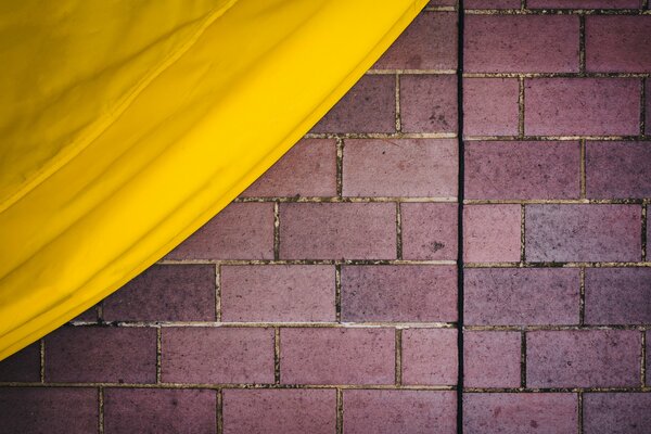 Brick wall and yellow fabric