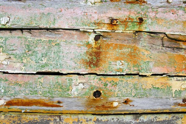 Peeling layers of paint on old boards