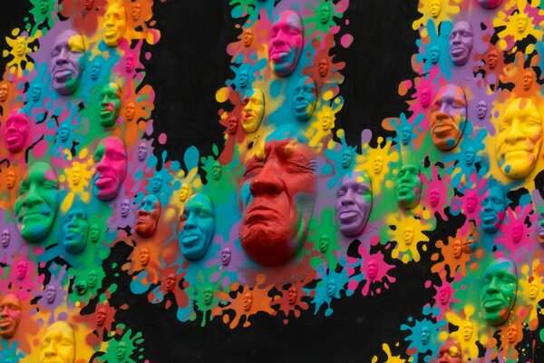 Multicolored faces blots on a black background