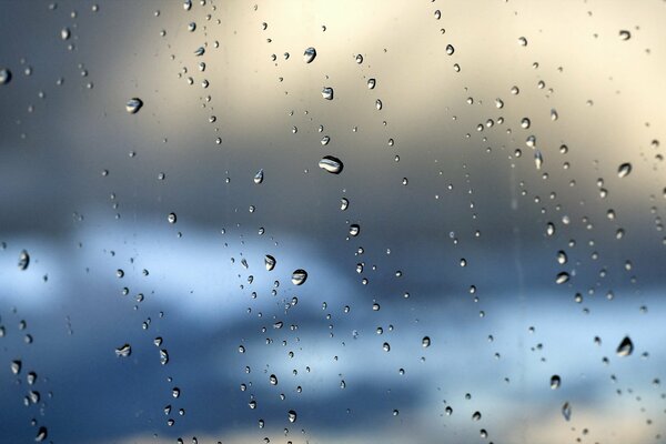 A lot of drops on the glass, and behind them the sky