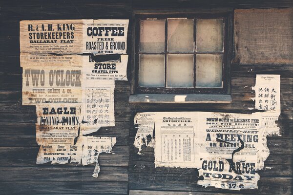 Worn ads on a wooden wall