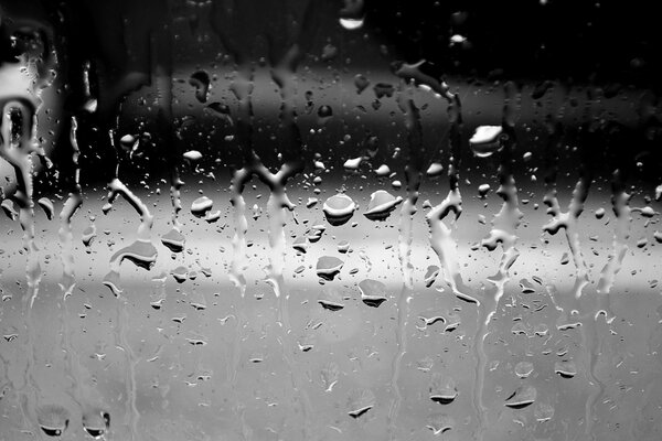 Raindrops on gray autumn glass