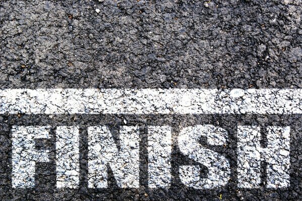 The word finish in white paint on asphalt