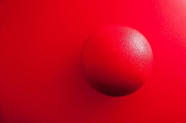 A red ball on a bright scarlet background