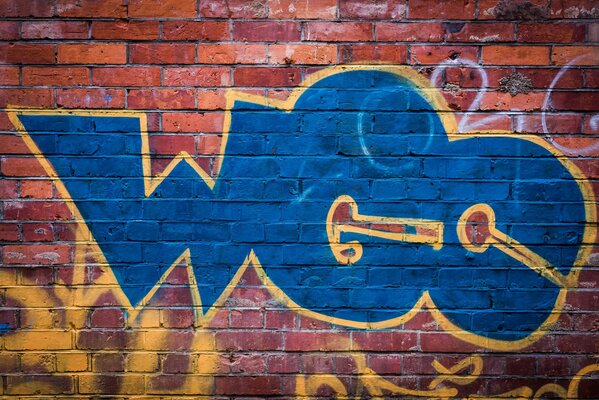 The wall is painted with graffiti in blue