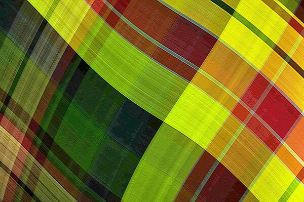 A smooth piece of fabric in a cage of green red and yellow colors