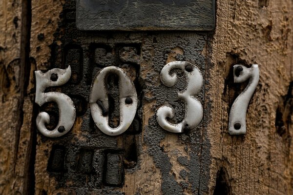 Old wooden door with a number