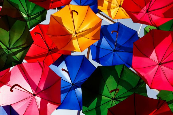 Lots of bright umbrellas in the sky