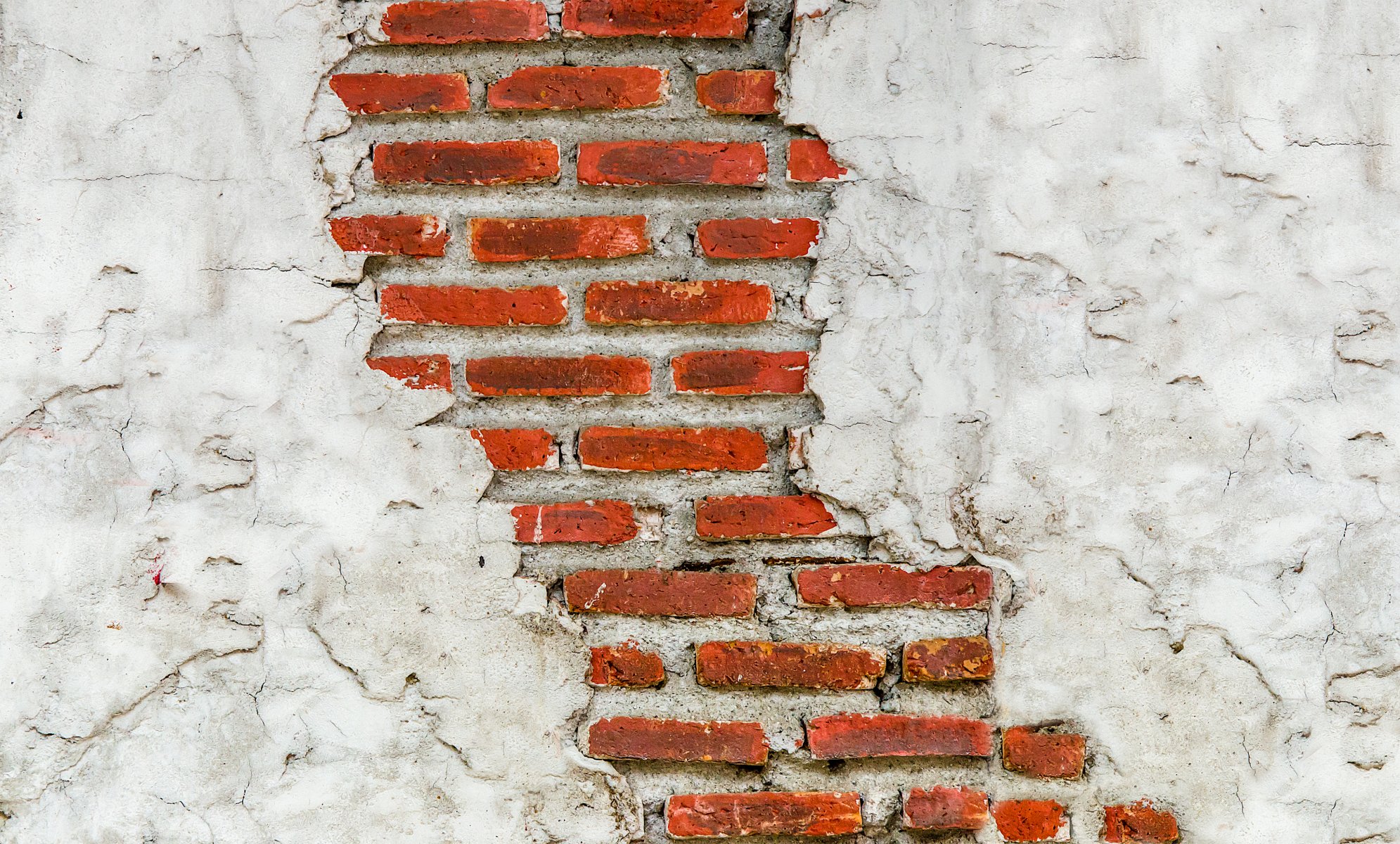 mur brique maçonnerie plâtre fissures texture