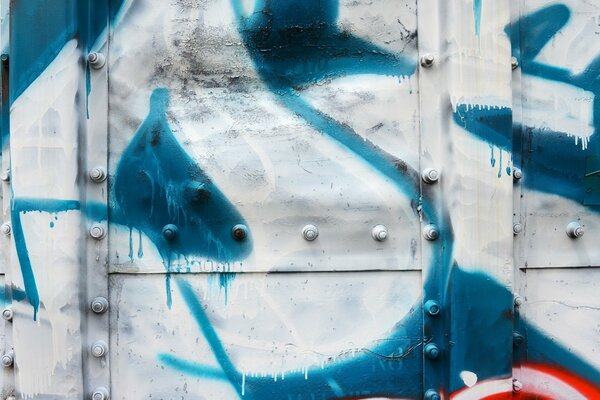 Graffiti on an iron wall with rivets