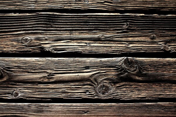 Vieux revêtement en bois dans des couleurs brun-noir