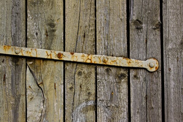 Wooden fence with rusty metal lining