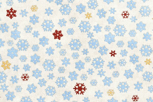 Stoffhintergrund - blaue Schneeflocken mit roten und gelben Flecken