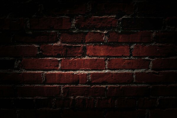 The wall is made of dark red brick