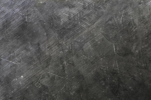 The texture of scratches on a black wall