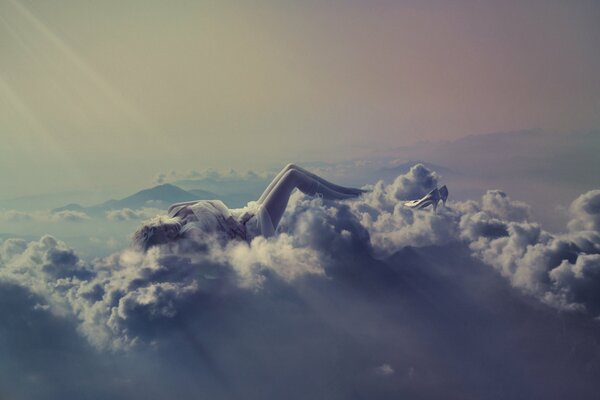 The girl is resting on a cloud, as if floating