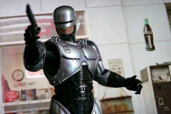 Robocop with a gun on the background of the office