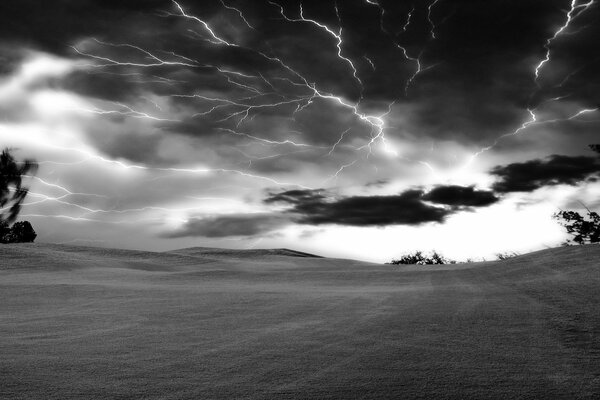 Black and white image of a thunderstorm in the field