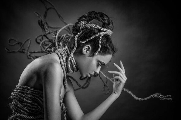 Black and white photo of a girl in ropes