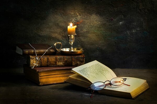 A candle stub. glasses. books. old books