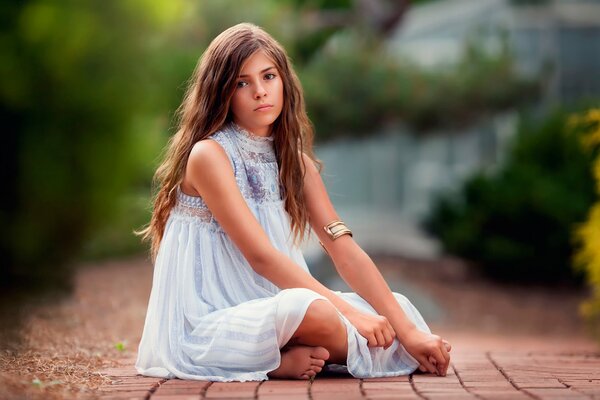 A girl with wavy hair in a dress