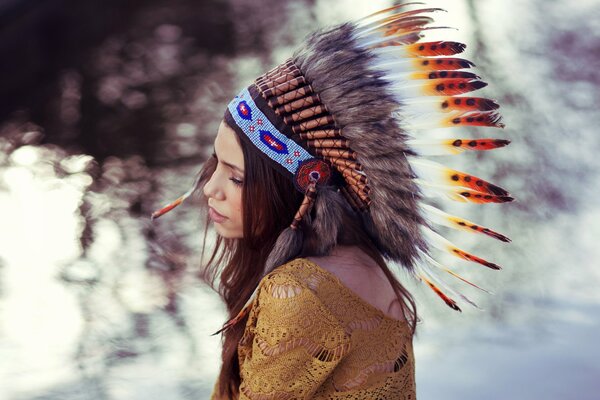 A girl poses in an Indian headdress