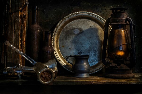 Still life with a meat grinder lamp and jug