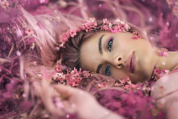 A beautiful girl lies in flowers