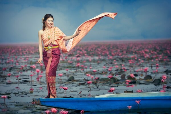 Oriental chica en un barco en flores