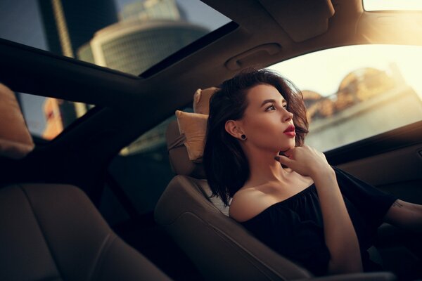 A girl in a car with a thoughtful look