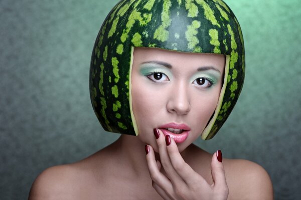 A girl with a watermelon peel on her head