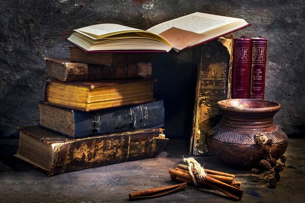 Antique books and a jug on a black table