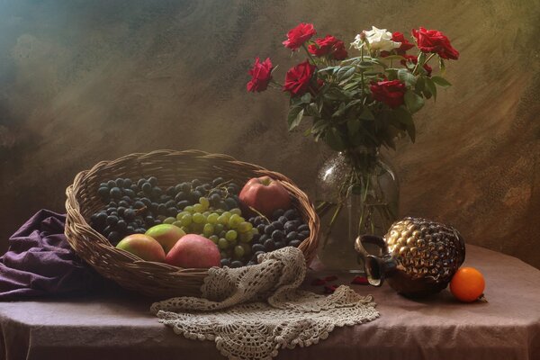 Still life with a picture of fruit in a basket and a vase with roses