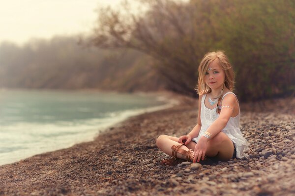 A girl on the shore of a lovely sea