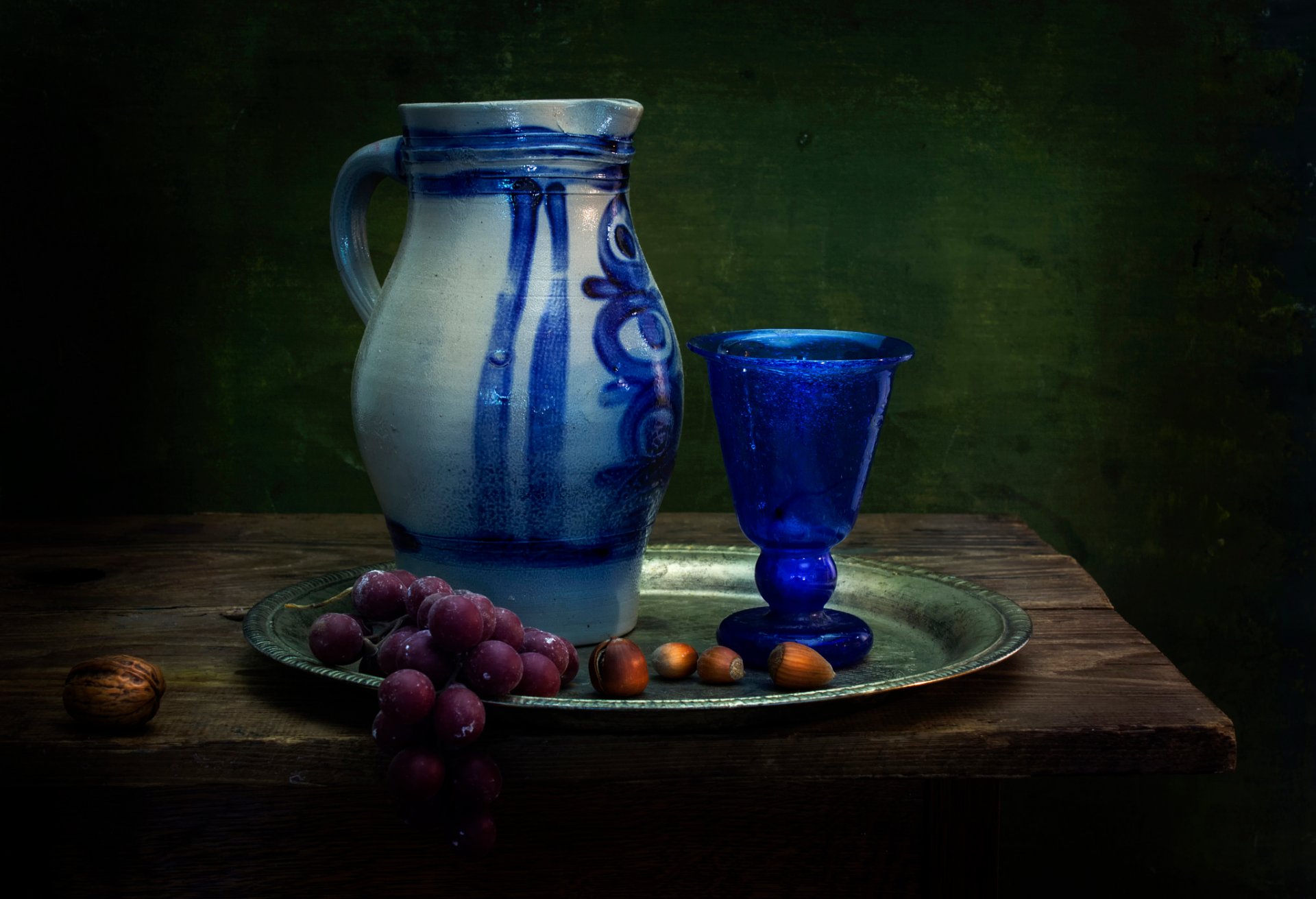 a dutch influence pitcher glass grapes nuts still life