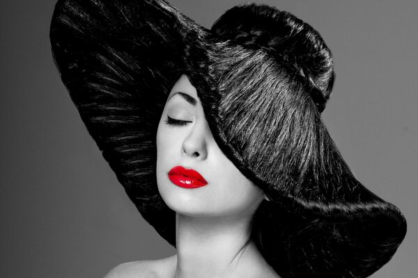 A gorgeous woman in a black hat and red lipstick