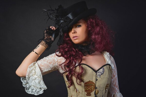 Gothic girl in a hat and corset