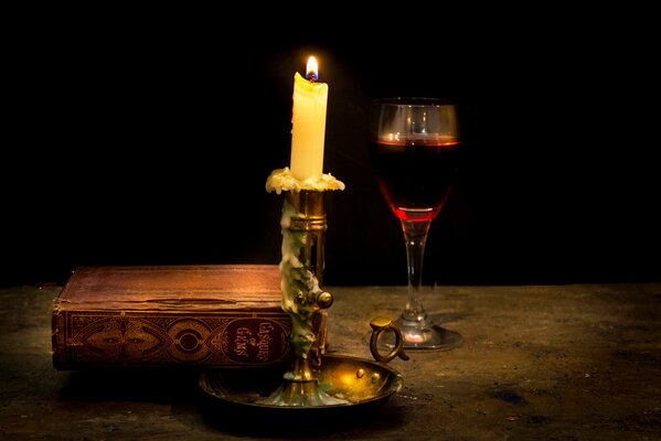 A beautiful candlestick near the book on the table